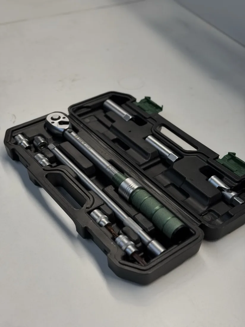 A torque wrench and its sockets in the case